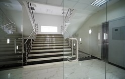 Glass doors with a kind on a marble staircase